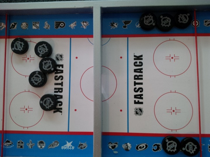 What the board looks like after over 50 plays (after a little quick-and-easy cleanup with a magic eraser). You can see specks where the coating on the pucks is starting to come off, but the logos are holding up well.